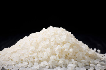 Raw Japanese rice served on a black background