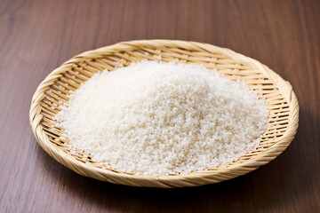 Raw Japanese rice in a bamboo sieve