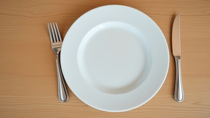 A Simple Place Setting An Empty White Plate with Fork and Knife on Wooden Table