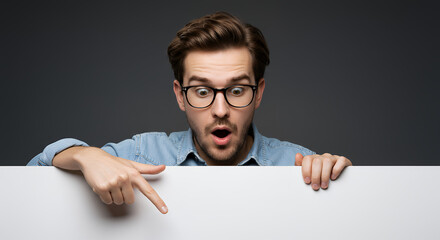 Shocked Man Pointing Down: Discover the Unexpected! Curious Reaction, Presentation Ready, Modern Mockup Space Awaits!