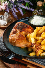 Crispy roasted chicken leg with french fries.