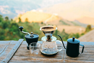 Drip coffee with mountains view,  drip coffee kit set with mountain in sunrise background..