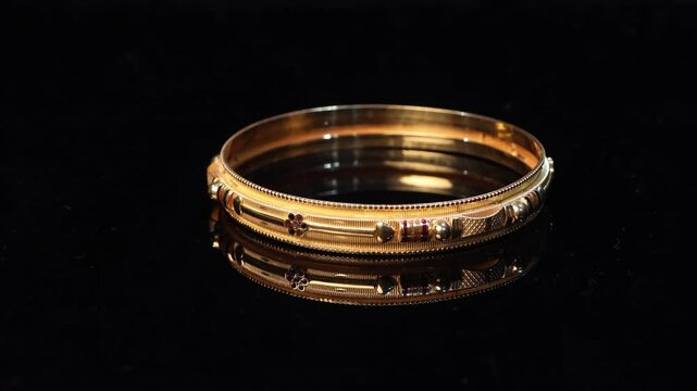 4k.Traditional Indian design gold bangle. Fancy designer antique golden Bangles also known as "sone ka Kada" or "sone ka kangan". Indian Temple jewellery exclusive collection with gemstones.