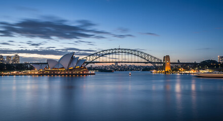 Naklejka premium Sydney at Dusk: Opera House & Harbour Bridge - Iconic Australian Landmarks in Evening Light