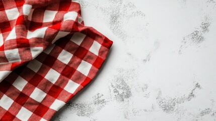 Red and white checkered kitchen cloth on a textured surface