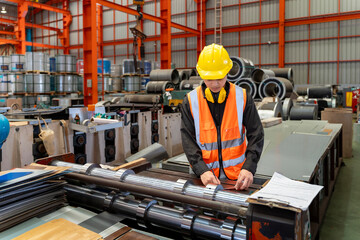 Engineering technician worker is measuring steel size from metal sheet forming machine inside the...