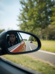 look in the rear view mirror of a car