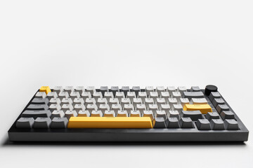 Mechanical keyboard for computer on white background. Key cap of grey, black and yellow colours.
