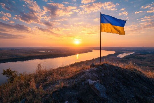 Ukraine flag atop a hill overlooking the Dnipro River at a majestic sunset, capturing hope and resilience.