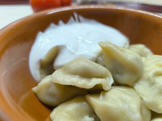 Delicious boiled dumplings lie in a clay plate