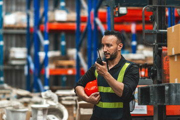 caucasian worker drive forklift using radio. adult employee driver lower lift to load shipping package on shelf at warehouse. caucasian supervisor drive cargo truck using transmitter do loading job