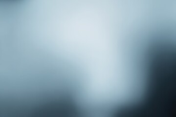 A soft, muted gray backdrop with subtle variations in tone.