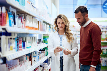 Pharmacist Assisting Customer in Selecting Healthcare Products in Pharmacy Aisle