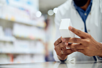 Pharmacist Checking Medicine Box in a Pharmacy for Prescription Review