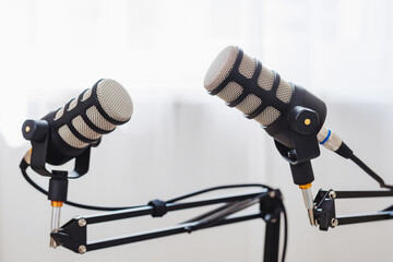 Two microphones ready for an engaging podcast interview in a bright studio setting