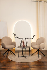 Podcast studio setup featuring microphones and comfortable seating in a modern interview space