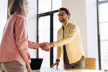 Business people shaking hands during meeting in modern office