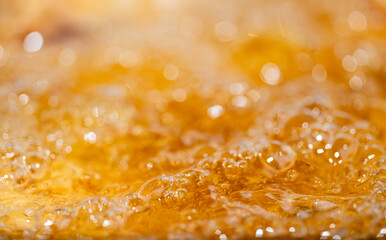Close up bright orange Oil or beer splash texture and nature waves, Beautiful waves curve and...