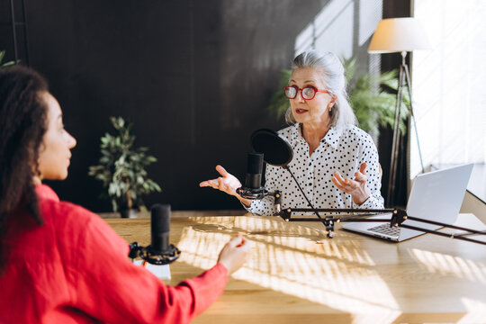 Radio hosts recording a podcast in a professional studio