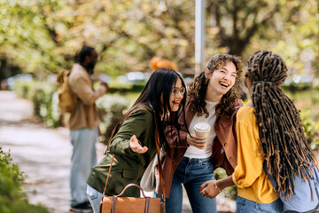 Students enjoy a sunny campus day while laughing and socializing during their college years