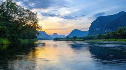 Fototapeta premium Serene sunset over a tranquil river, reflecting the golden light against lush green vegetation and majestic karst mountains in a picturesque landscape. : Generative AI