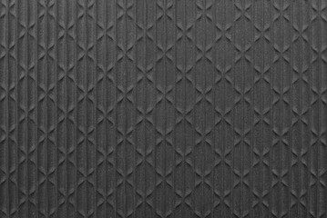 Texture of black material with geometric shapes. Abstract black pattern