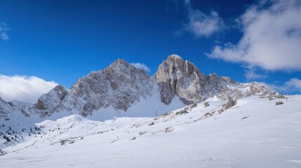 Majestic snow-capped peaks rise against a vibrant blue sky, showcasing a breathtaking winter mountain landscape. : Generative AI