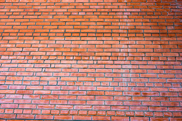 .    Weathered red brick wall with visible grout lines arranged in a horizontal pattern, background image