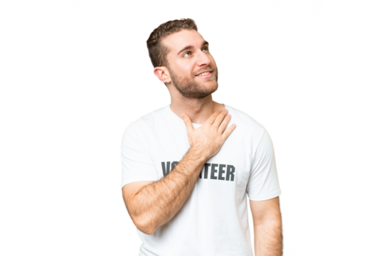 Young volunteer man over isolated chroma key background looking up while smiling