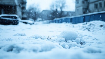 A small plant struggles to peek through a thick blanket of snow during a gentle snowfall, with blurred city buildings and parked cars in the background. : Generative AI