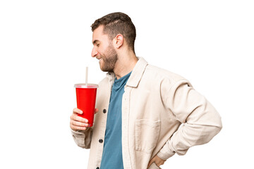 Young handsome blonde man holding soda over isolated chroma key background suffering from backache...