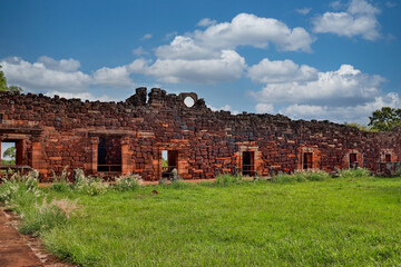 Fascinating contrast: azure sky with clouds enhances the history of San Ignacio Mini Misiones. Natural light bathes the ruins with serenity.