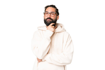 Young man with beard over isolated chroma key background having doubts and thinking