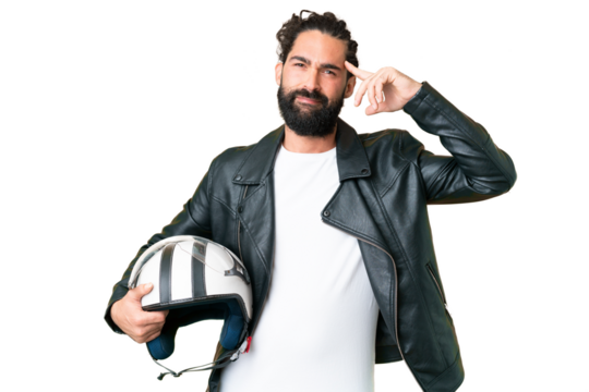 Young man with beard with a motorcycle helmet over isolated chroma key background having doubts and thinking