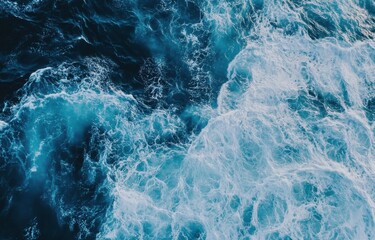 Fototapeta premium Aerial view of ocean waves, showing a dynamic interplay of deep blue water and white foam, creating a textured and powerful seascape. : Generative AI