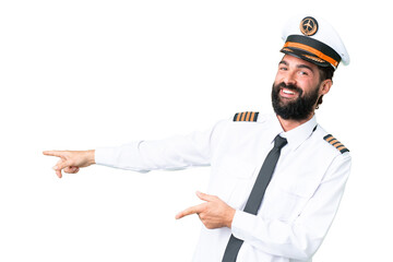 Airplane caucasian pilot man over isolated chroma key background pointing finger to the side and presenting a product © luismolinero