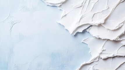 Obraz premium Abstract image of white cream texture on a light blue textured background, ideal for cosmetic product advertising or design projects. The contrast between the smooth cream and the roug : Generative AI