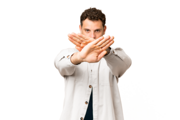 Brazilian man over isolated chroma key background making stop gesture with her hand to stop an act