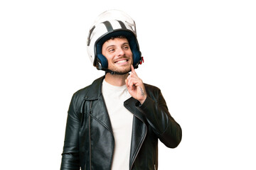 Brazilian man with a motorcycle helmet over isolated chroma key background thinking an idea while looking up