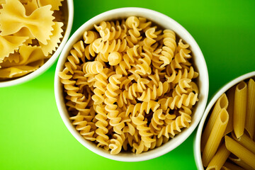  Three bowls of Healthy Farfalle, Penne and Fusilli Italian Pasta Ready to Cook