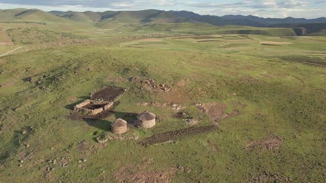 Rural Basotho homestead atop vast grassy hilltop in Lesotho, seen from above