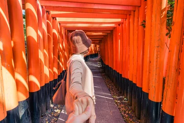 Fotobehang Asian woman enjoying in tunnel of red torii gates lines at Fushimi Inari, Kyoto © Mumemories