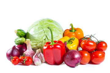 Mix of colorful vegetables - bell pepper, cabbage, tomatoes, cucumbers, onions and garlic. Isolated on white.