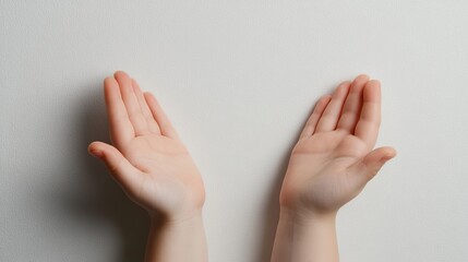 Child's hands reaching up, palms open, against a textured neutral wall. Hope, support, offering, innocence.