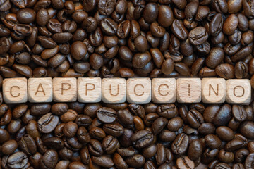 Cappuccino letters on coffee bean background: rustic wooden block art