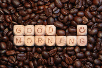 Good morning message on coffee beans background with wooden blocks smile