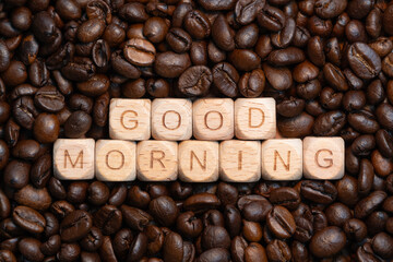 Good morning message with wooden blocks on coffee beans background