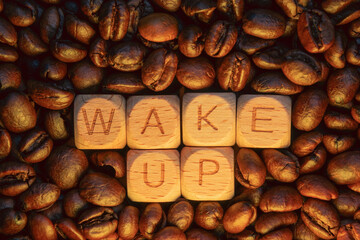 Wake up message with coffee beans surrounding wooden blocks letters