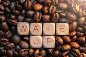 Wooden blocks spelling 'wake up' surrounded by coffee beans