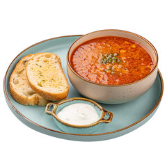 Isolated slavic traditional red sour soup solyanka with toast and cream